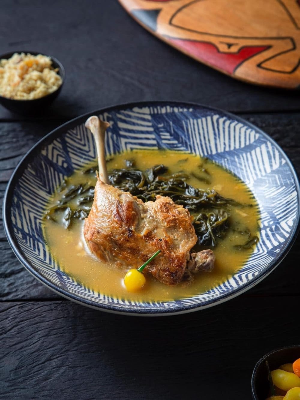 Pato no tucupi: a golden duck leg in yellow tucupi broth with jambu leaves, served with rice