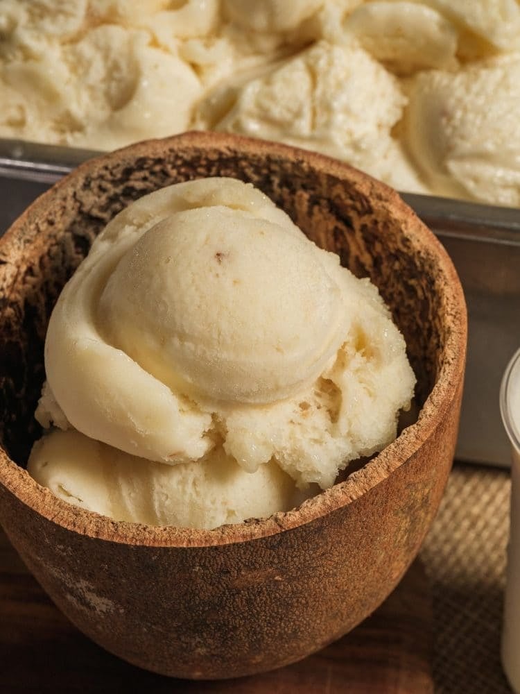 Scoops of handmade cupuaçu ice cream served in a cupuaçu shell