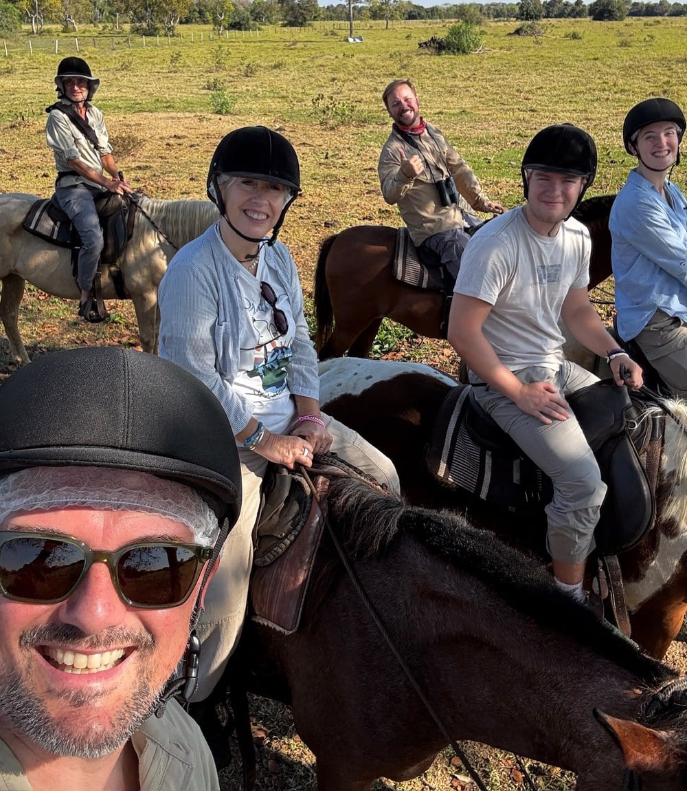 Sally and her family on horseback with riding helmets on the Pantanal ranch