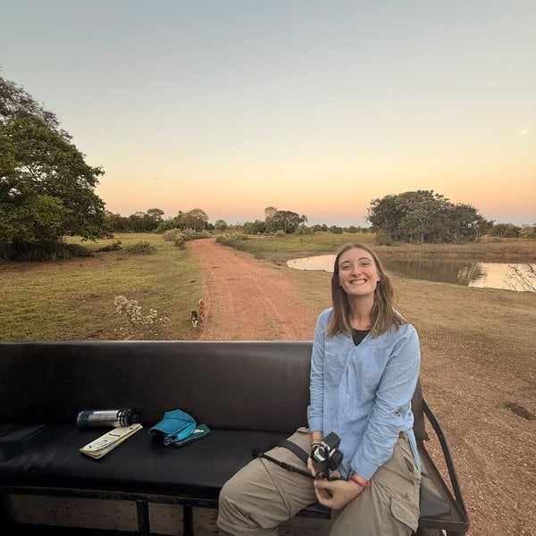 Sally's daughter sitting on the safari truck bench at dusk