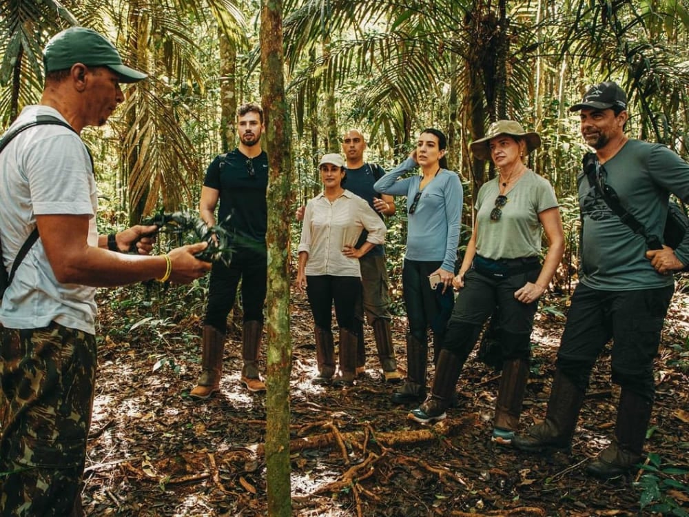 Guia local explicando a flora para um grupo de turistas durante uma caminhada na selva da Floresta Amazônica. Guia local explicando a flora para um grupo de turistas durante uma caminhada na selva da Floresta Amazônica.