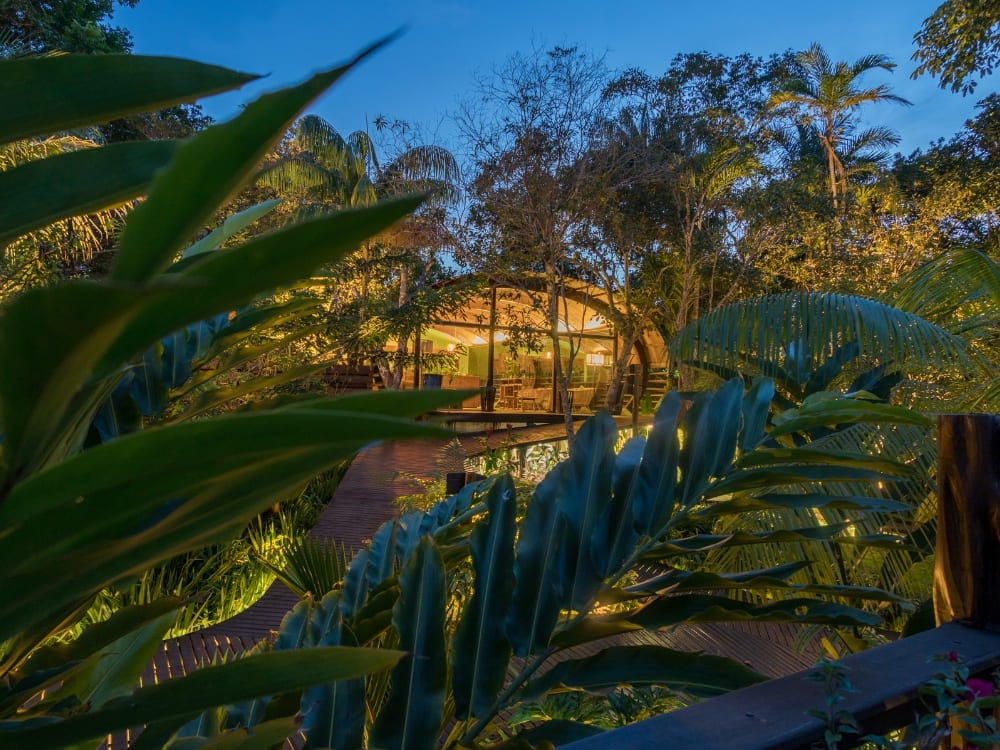The illuminated wooden architecture of Mirante do Gavião at night, one of the best Amazon lodges in Brazil located near Anavilhanas National Park. The illuminated wooden architecture of Mirante do Gavião at night, one of the best Amazon lodges in Brazil located near Anavilhanas National Park.