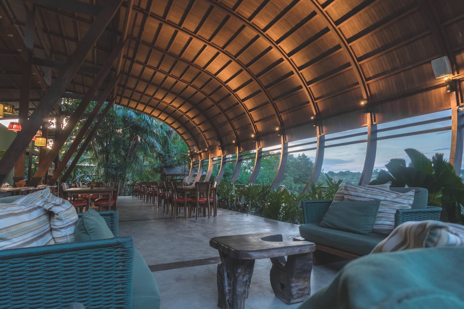 Le genre d'endroit qui vous convainc de rester un jour de plus. Le restaurant du Mirante do Gavião avec son plafond en bois incurvé, ses canapés en rotin et ses larges baies vitrées ouvertes sur la canopée amazonienne au crépuscule