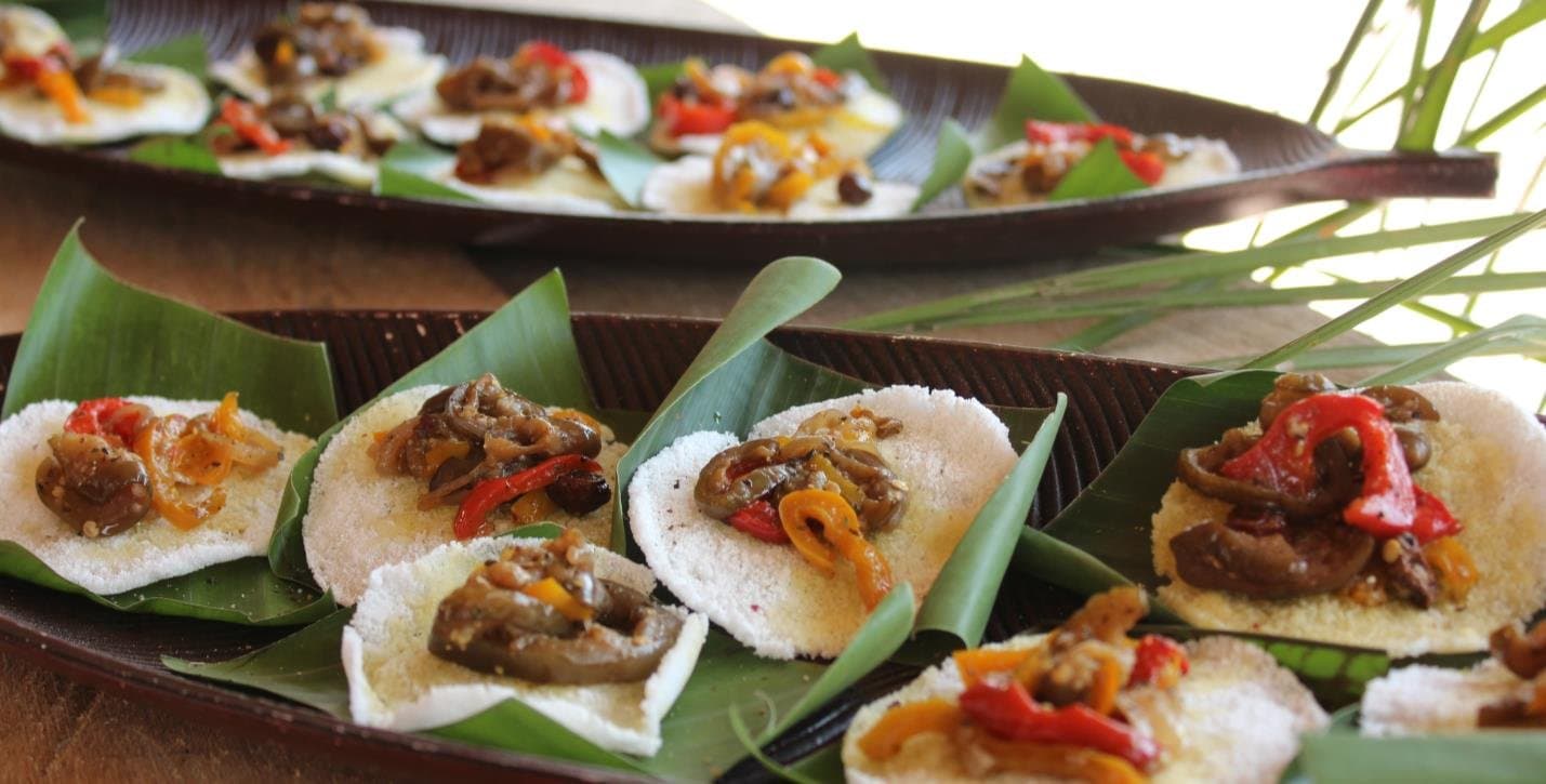La cuisine amazonienne dans toute sa générosité, sans chichi. Petites galettes de manioc blanc garnies de poivrons et légumes sautés, dressées sur des feuilles de bananier lors d'une croisière en Amazonie depuis Alter do Chão