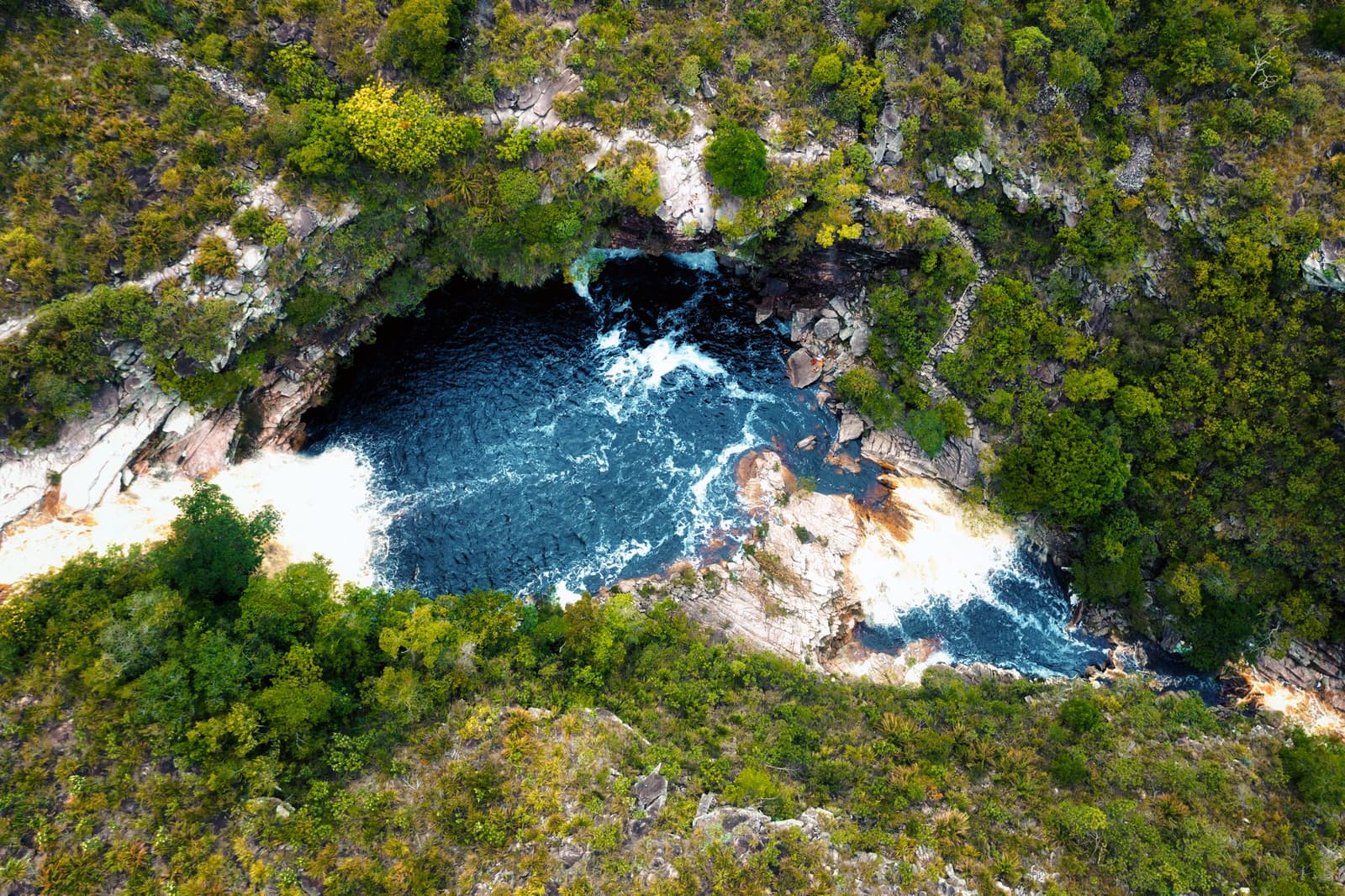 Deep blue and untamed — a natural pool swirling between ancient rocks at the end of the trail. Photo: golero Photo 2