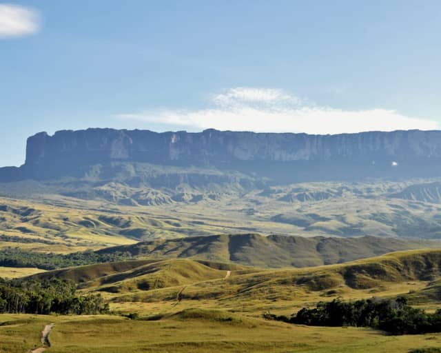 Mount Roraima's flat-topped tepui rising above the green Gran Sabana savanna in Venezuela Mount Roraima's flat-topped tepui rising above the green Gran Sabana savanna in Venezuela