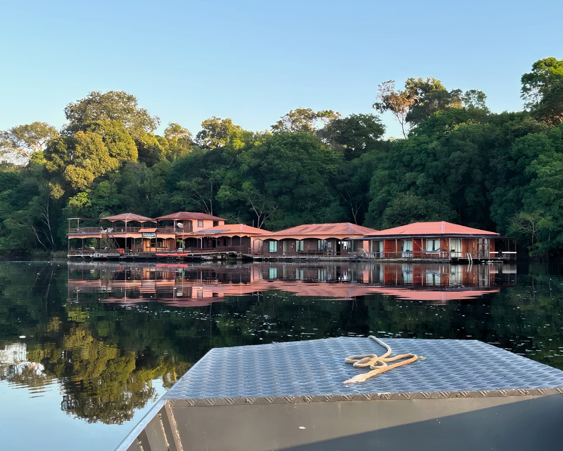 Amazon eco floating lodge on the Rio Negro seen from the boat at sunrise Amazon eco floating lodge on the Rio Negro seen from the boat at sunrise