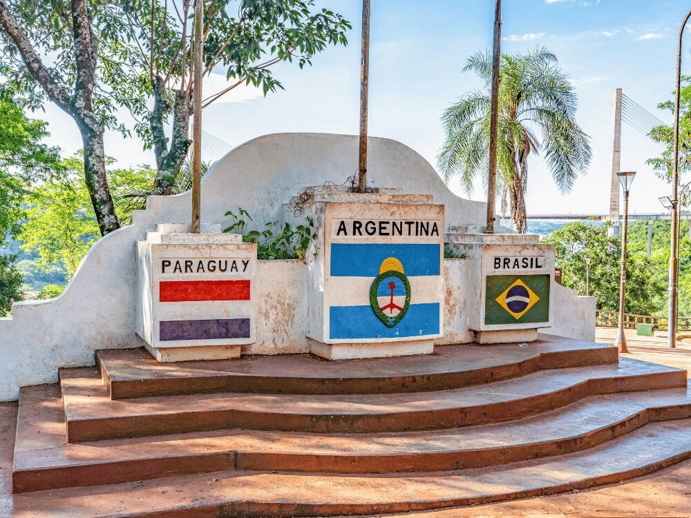 Photo: jimfeng Three Borders Landmark with the flags of Paraguay, Argentina and Brazil