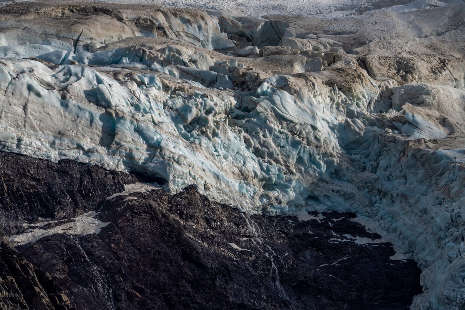 Millions of years of pressure, right there at the trail's end. Fractured blue-white ice meets dark exposed rock at the edge of Grey Glacier, a highlight of the self-guided W Trek through Torres del Paine National Park.